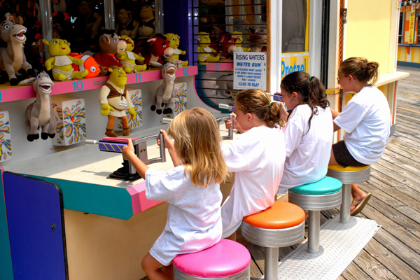 Children play a carnival game at Wildwoods Boardwalk.